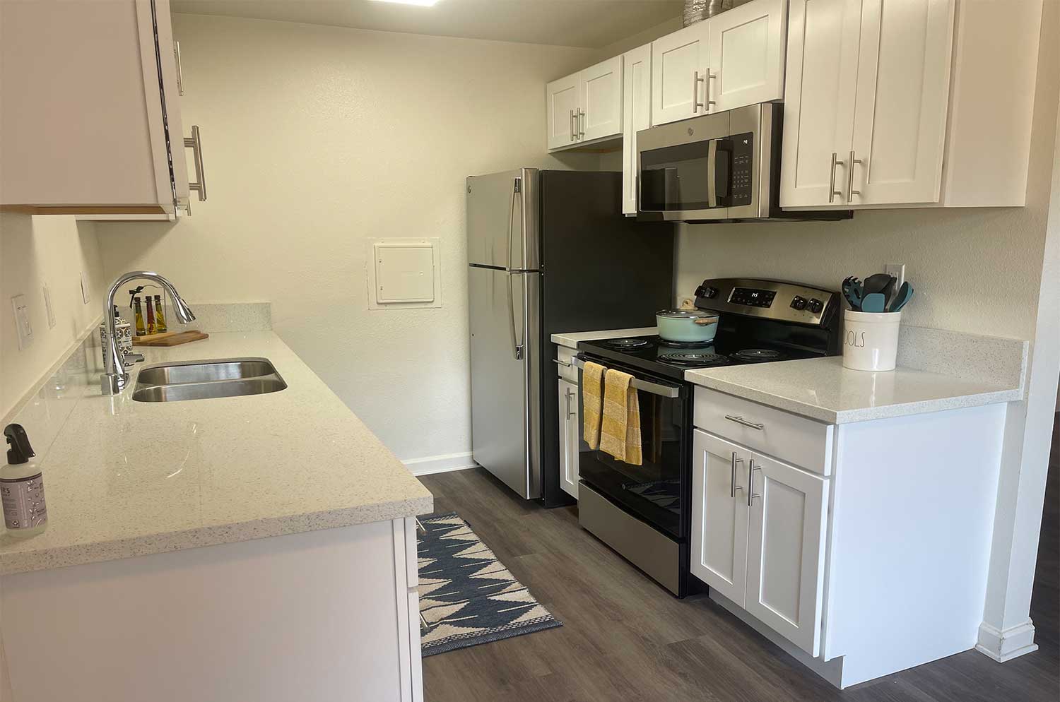 Artesia Crossings Apartment kitchen with stainless steel appliances and laminate countertops